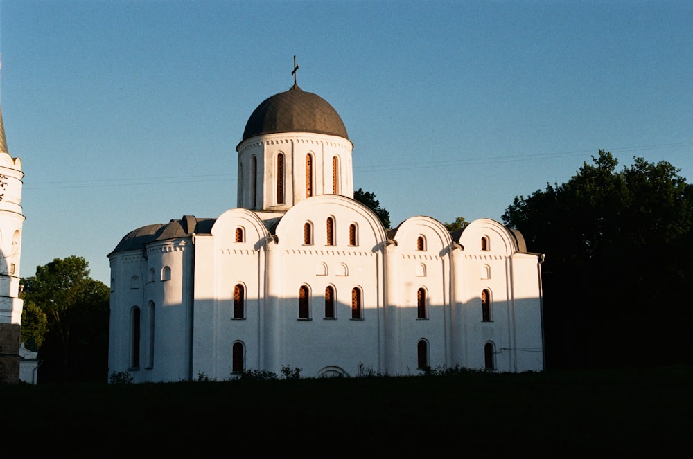 a large white building with a black roof