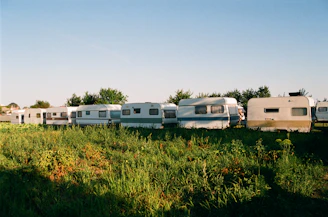 a group of rvs are parked in a field
