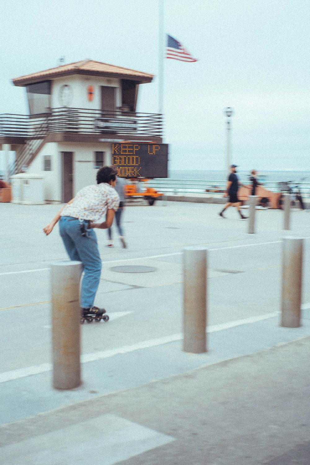 a man riding a skateboard down the side of a sidewalk