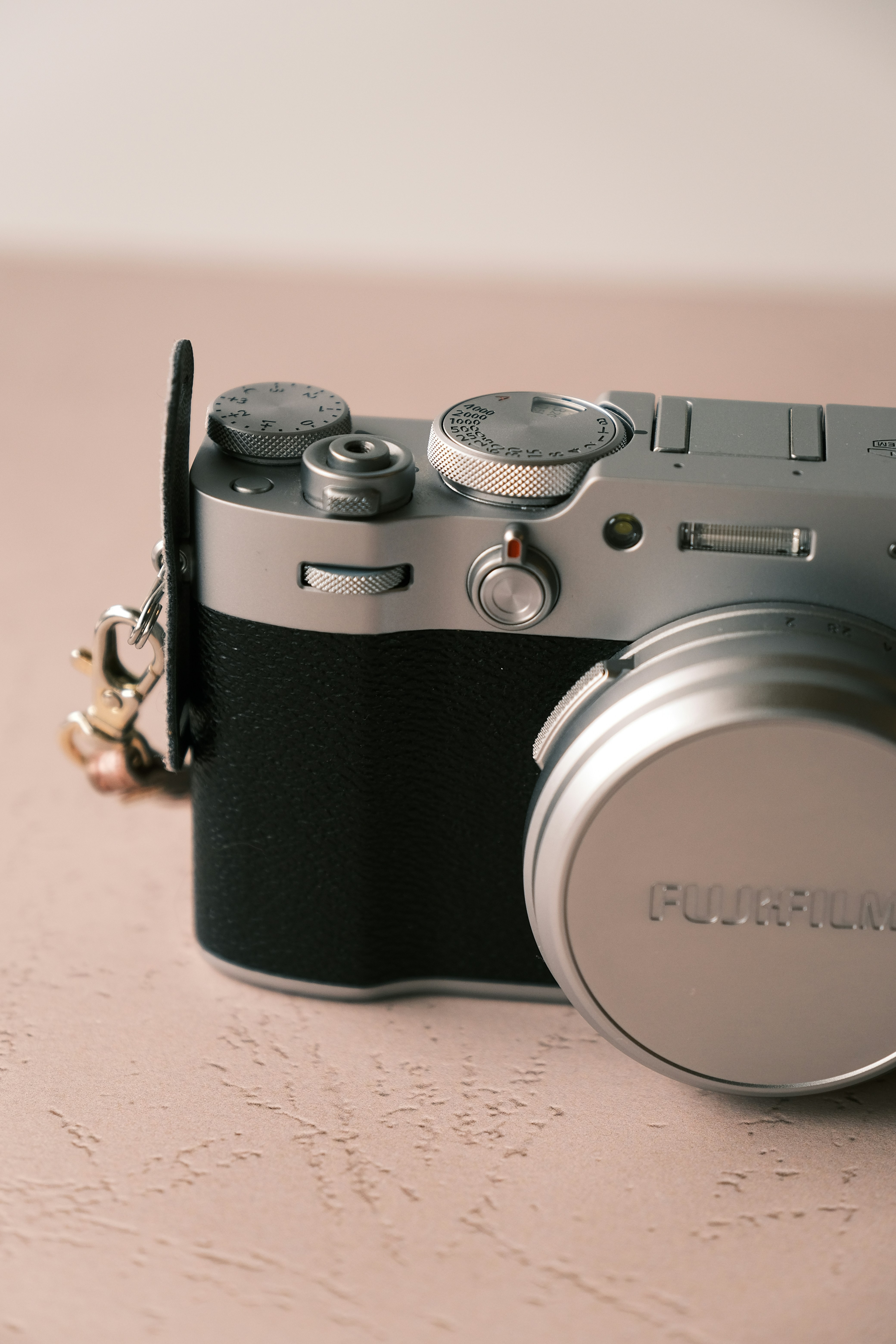 a silver and black camera sitting on a table