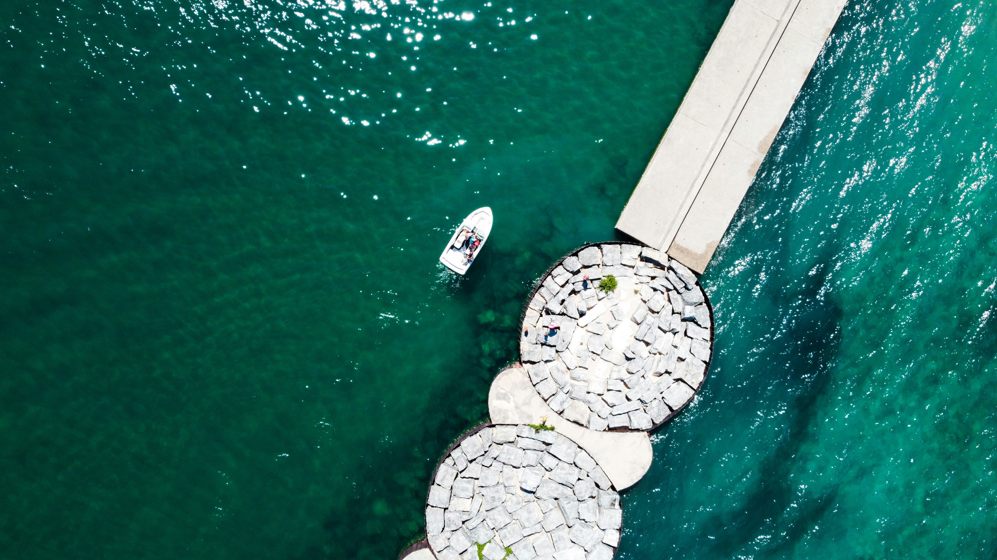 a couple of boats floating on top of a body of water