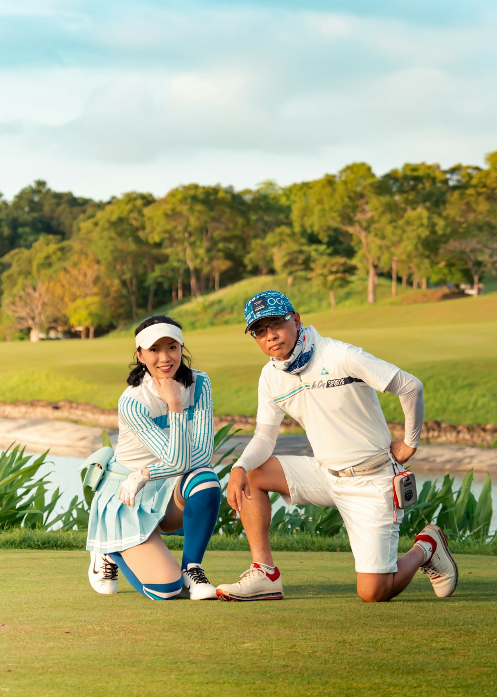 a man and a woman posing for a picture on a golf course