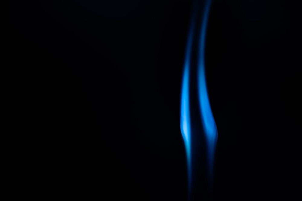 a blurry photo of a blue flame on a black background