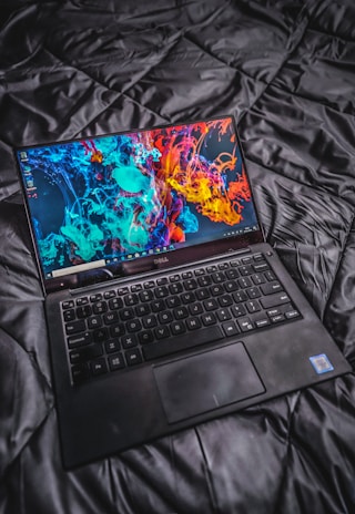 a laptop computer sitting on top of a bed