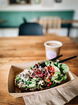 A visionary consultant presenting innovative food ideas to a client over coffee.