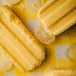 a yellow and white checkered table cloth with ice cream and lemon slices