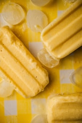 a yellow and white checkered table cloth with ice cream and lemon slices