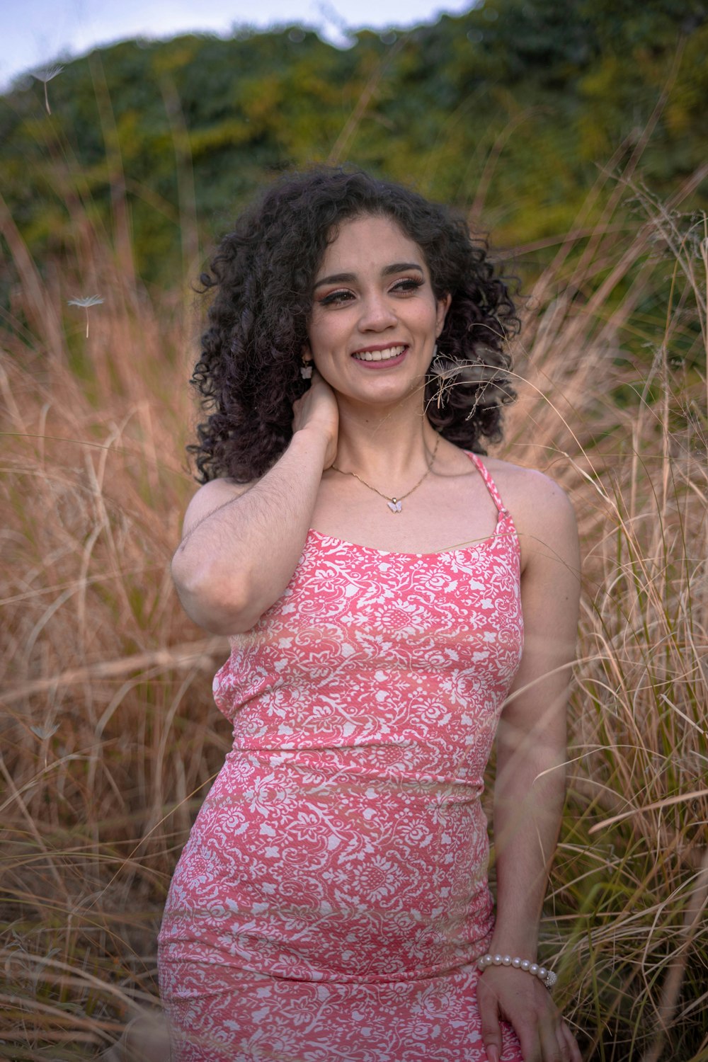 a woman standing in a field of tall grass