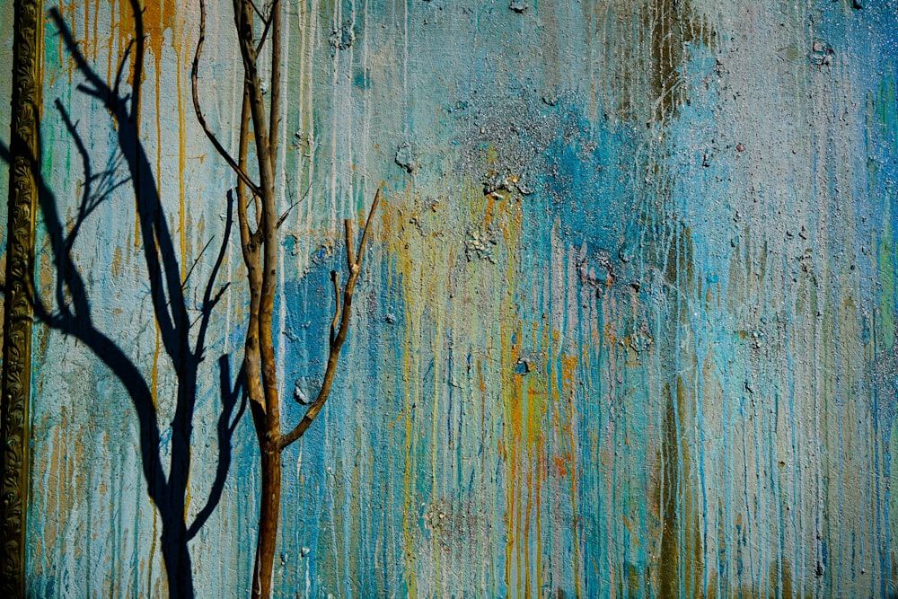 a painting of a tree with a blue background