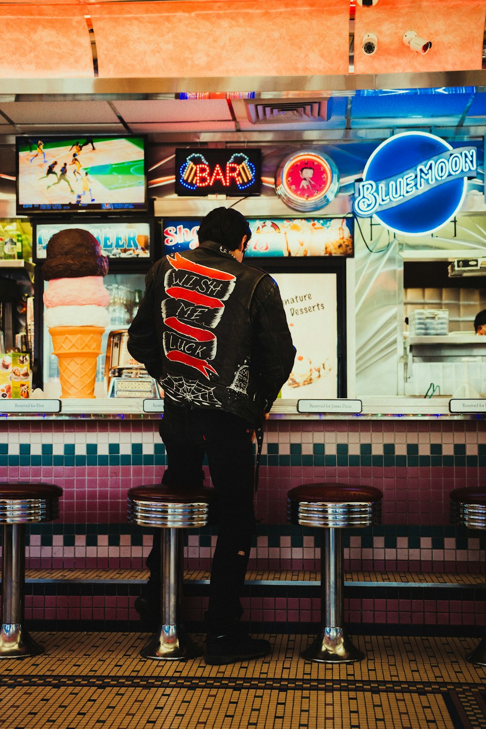 a man sitting on a bench in front of a restaurant