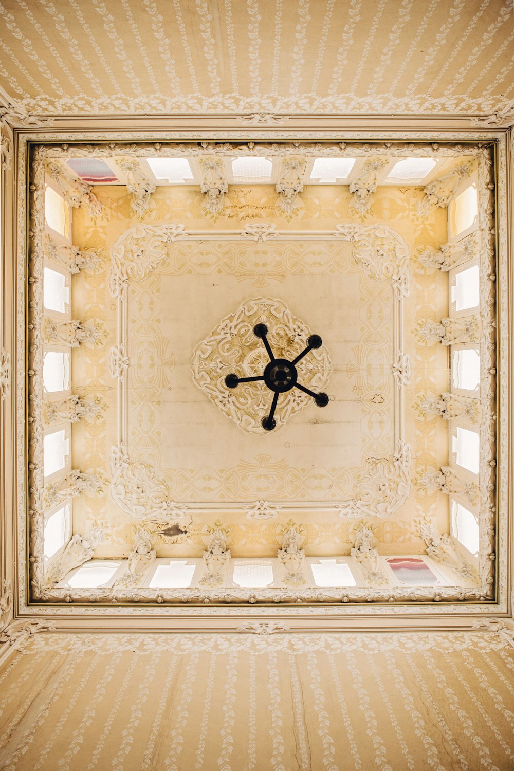 a ceiling with a clock in the middle of it