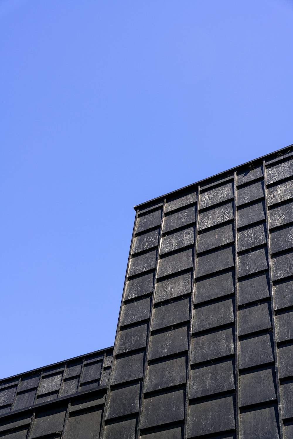 a black building with a blue sky in the background