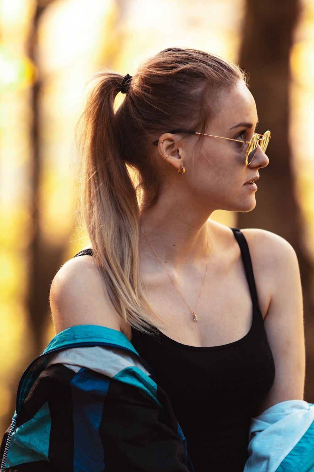 a woman with a ponytail wearing glasses
