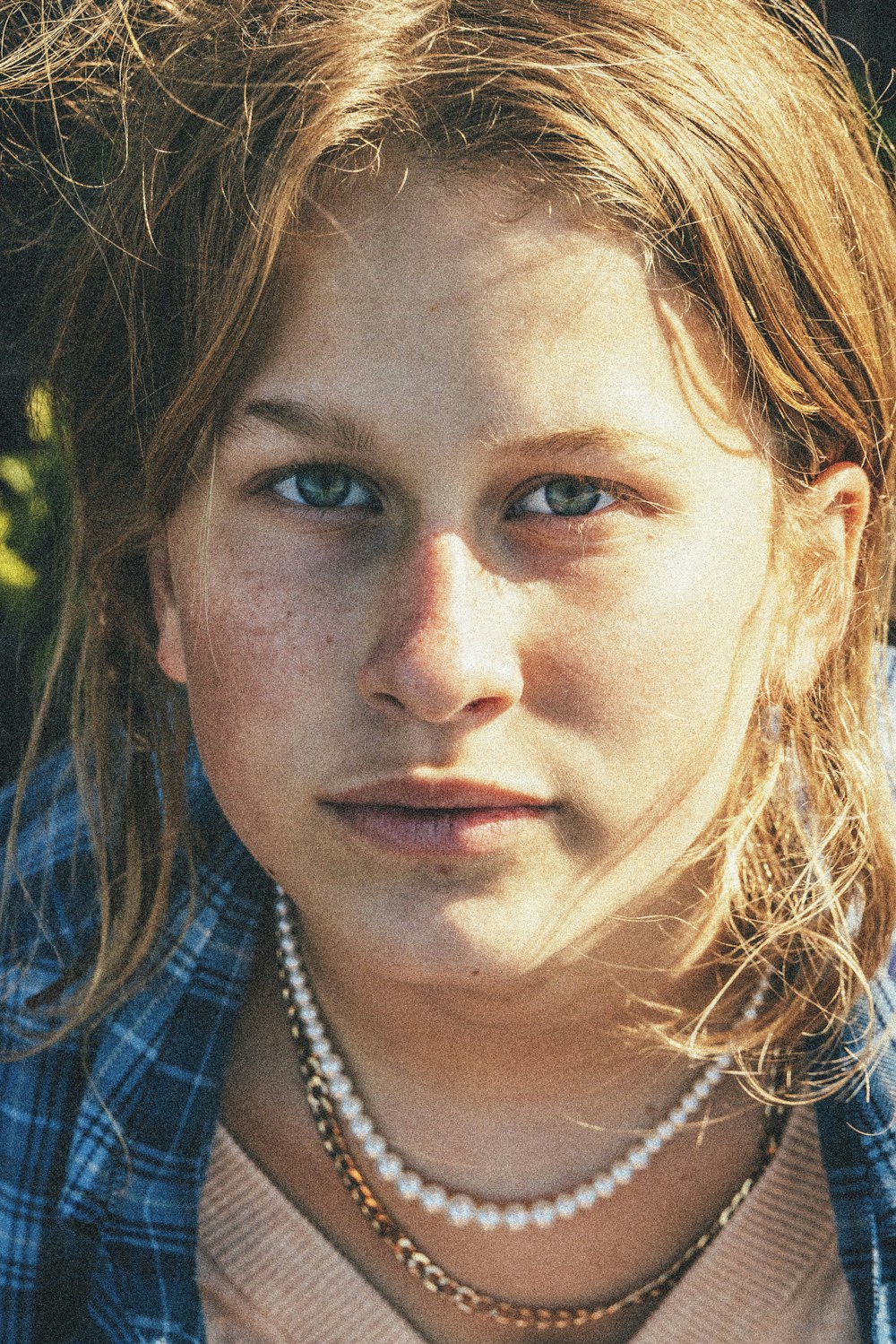 a close up of a person wearing a necklace