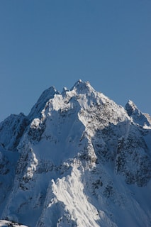 snow covered mountain under blue sky during daytime