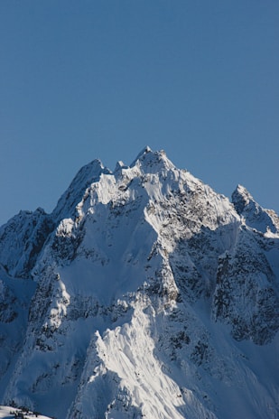 snow covered mountain under blue sky during daytime