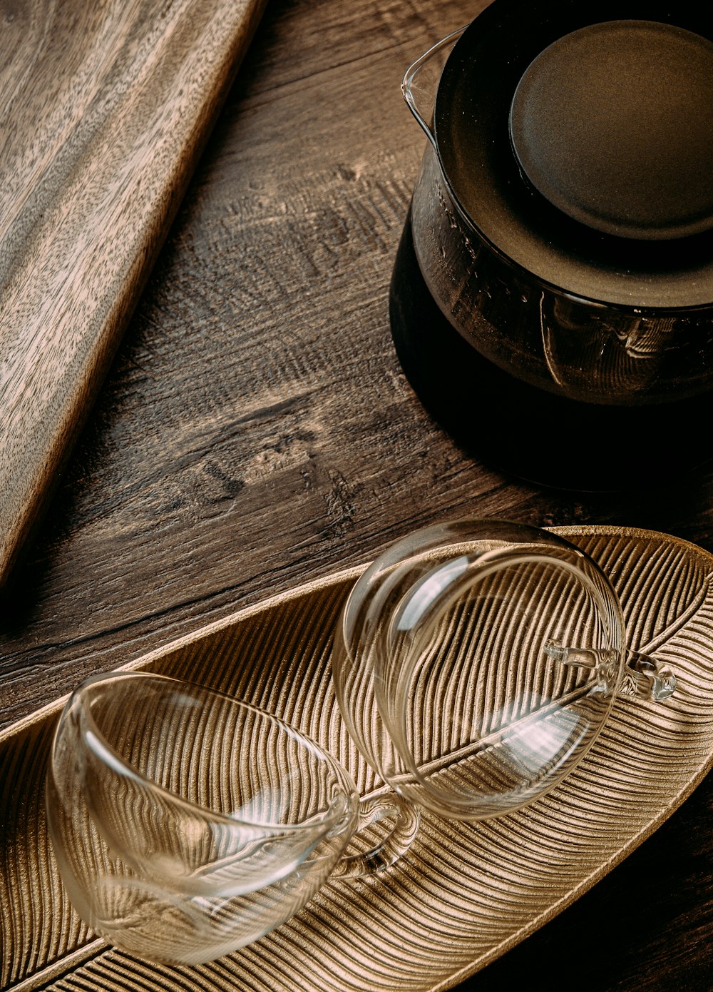a pair of glasses sitting on top of a wooden plate
