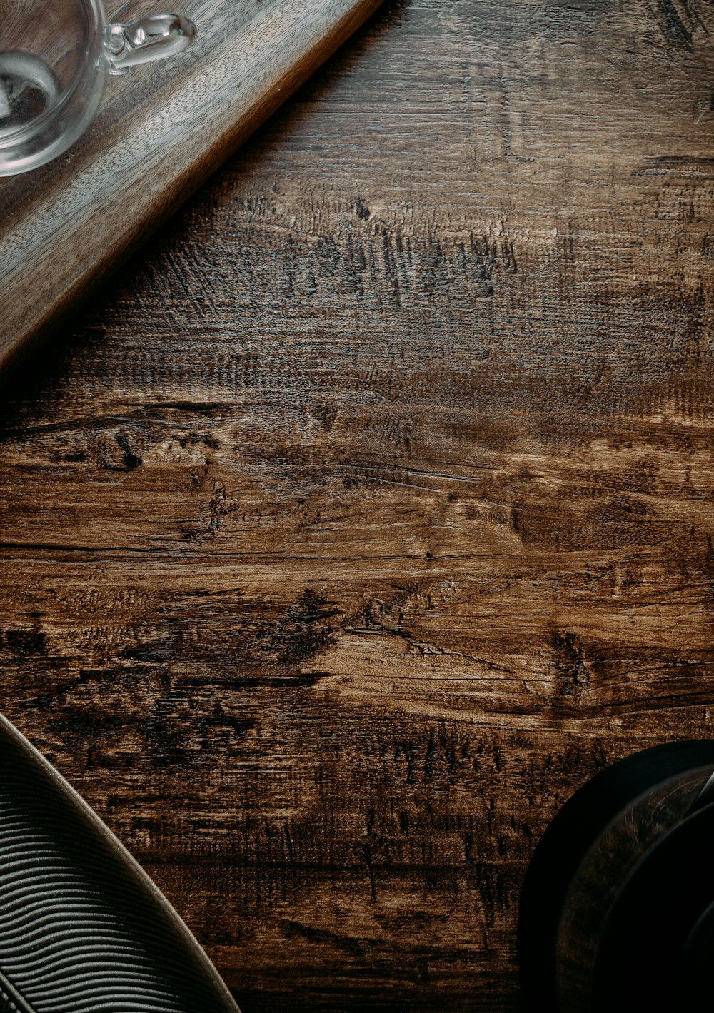 brown wooden table with black leather shoe