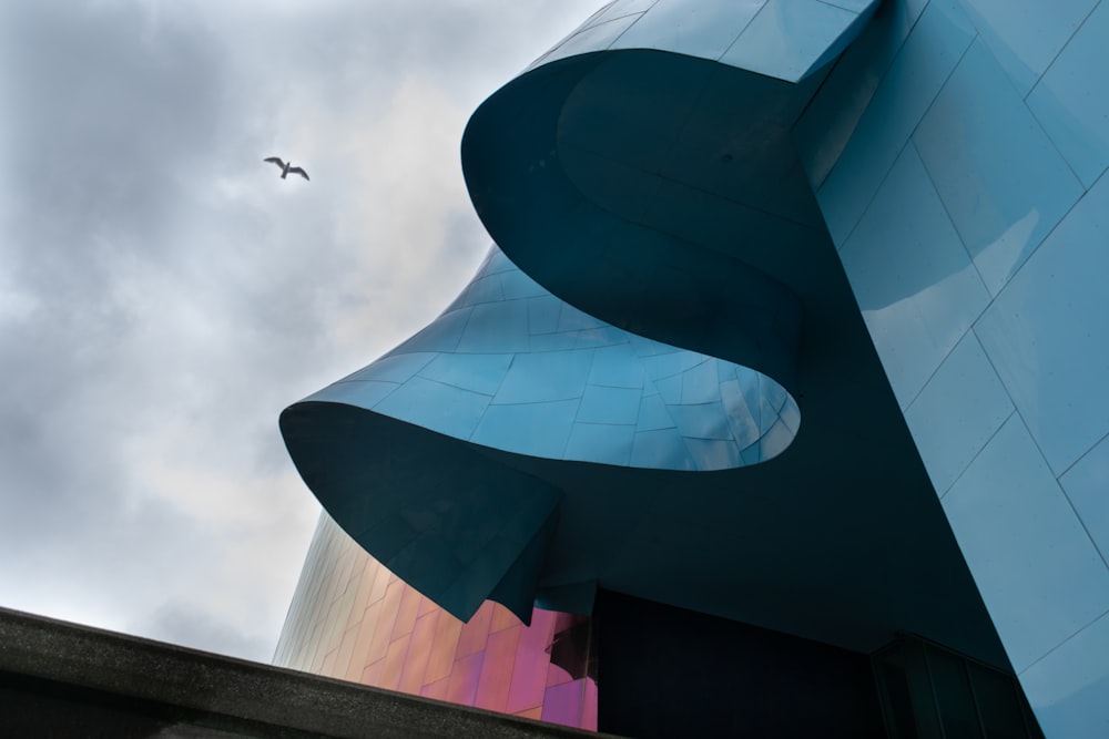 a building with a bird flying in the sky