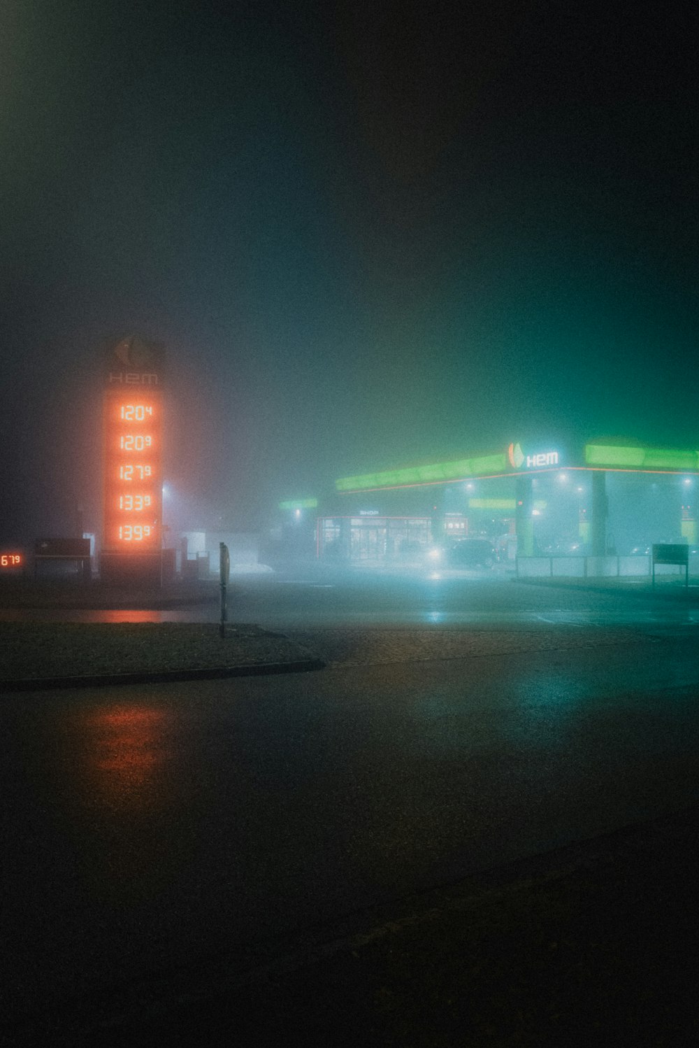 a gas station in the fog at night