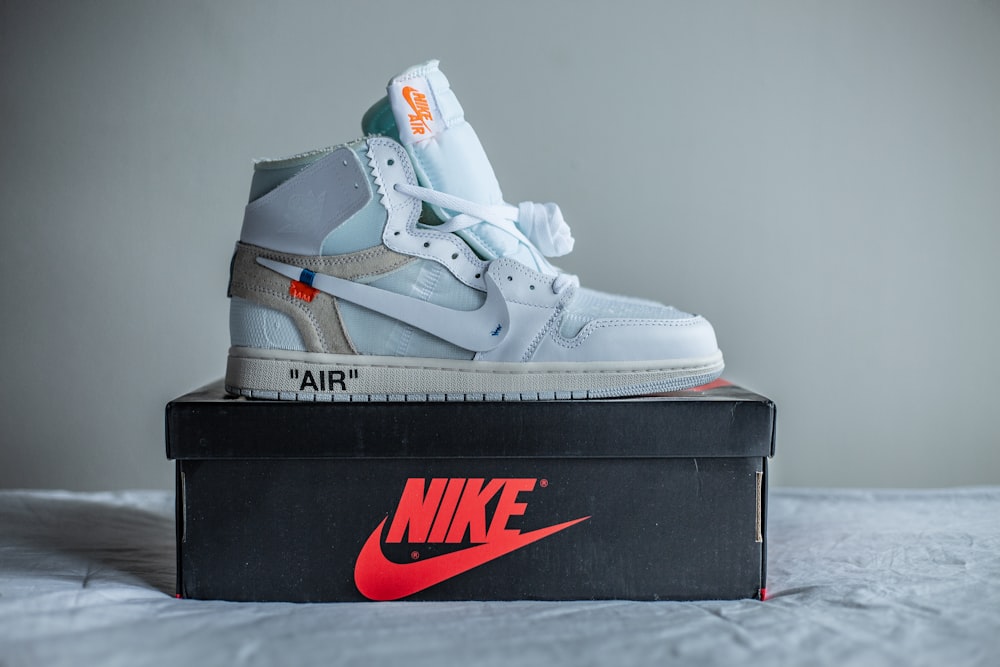 a pair of sneakers sitting on top of a box