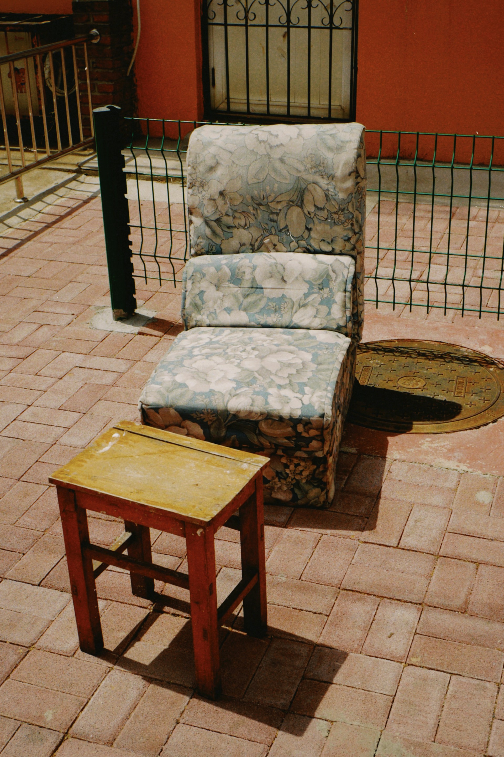 a chair and a table on a brick patio