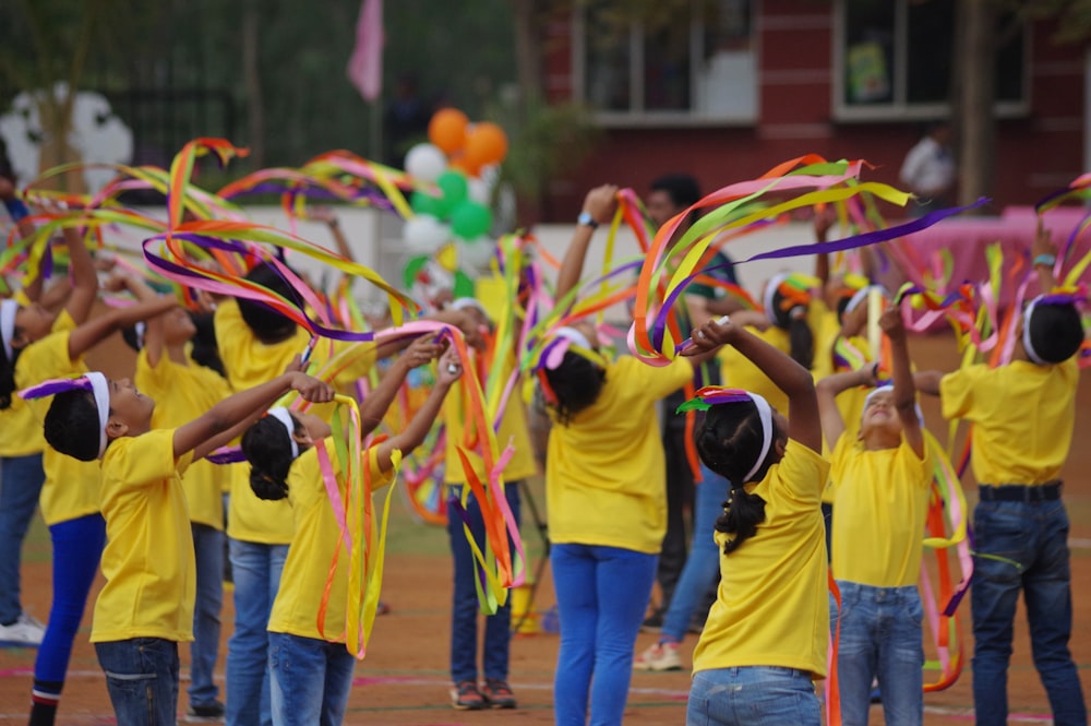 a group of people in yellow shirts holding streamers