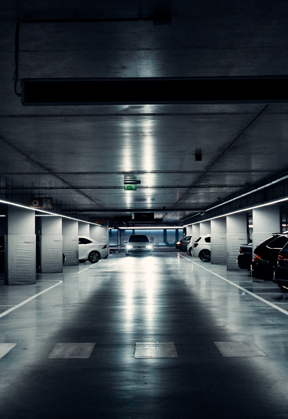 Underground parking garage with parked cars at night