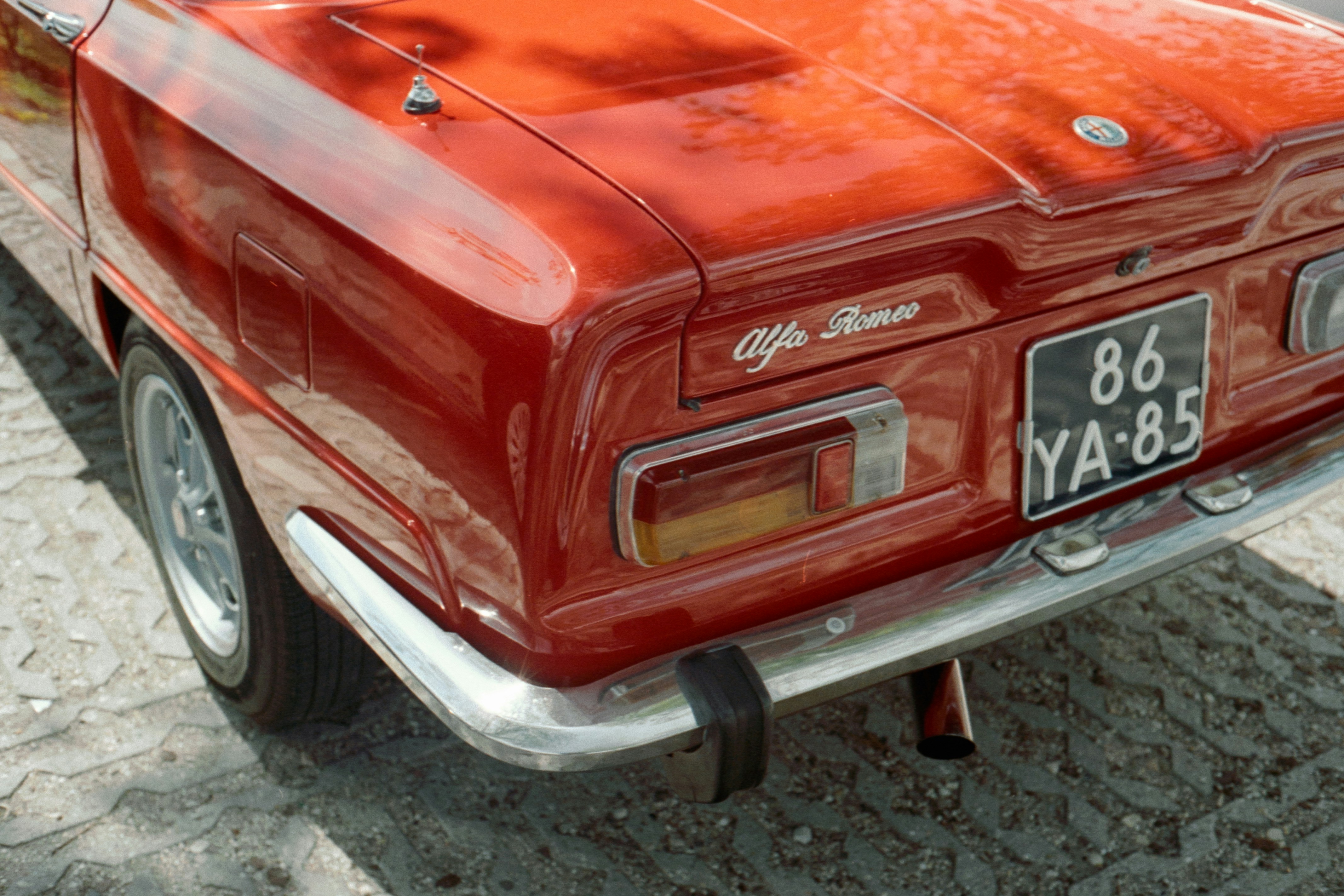 Fotomural a red car parked on the side of the road