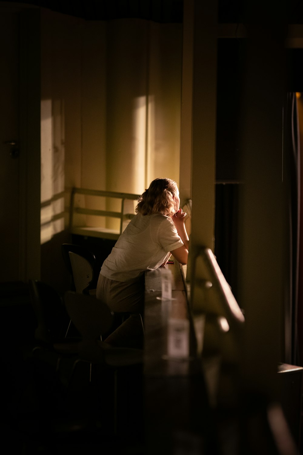 woman in white long sleeve shirt sitting on chair