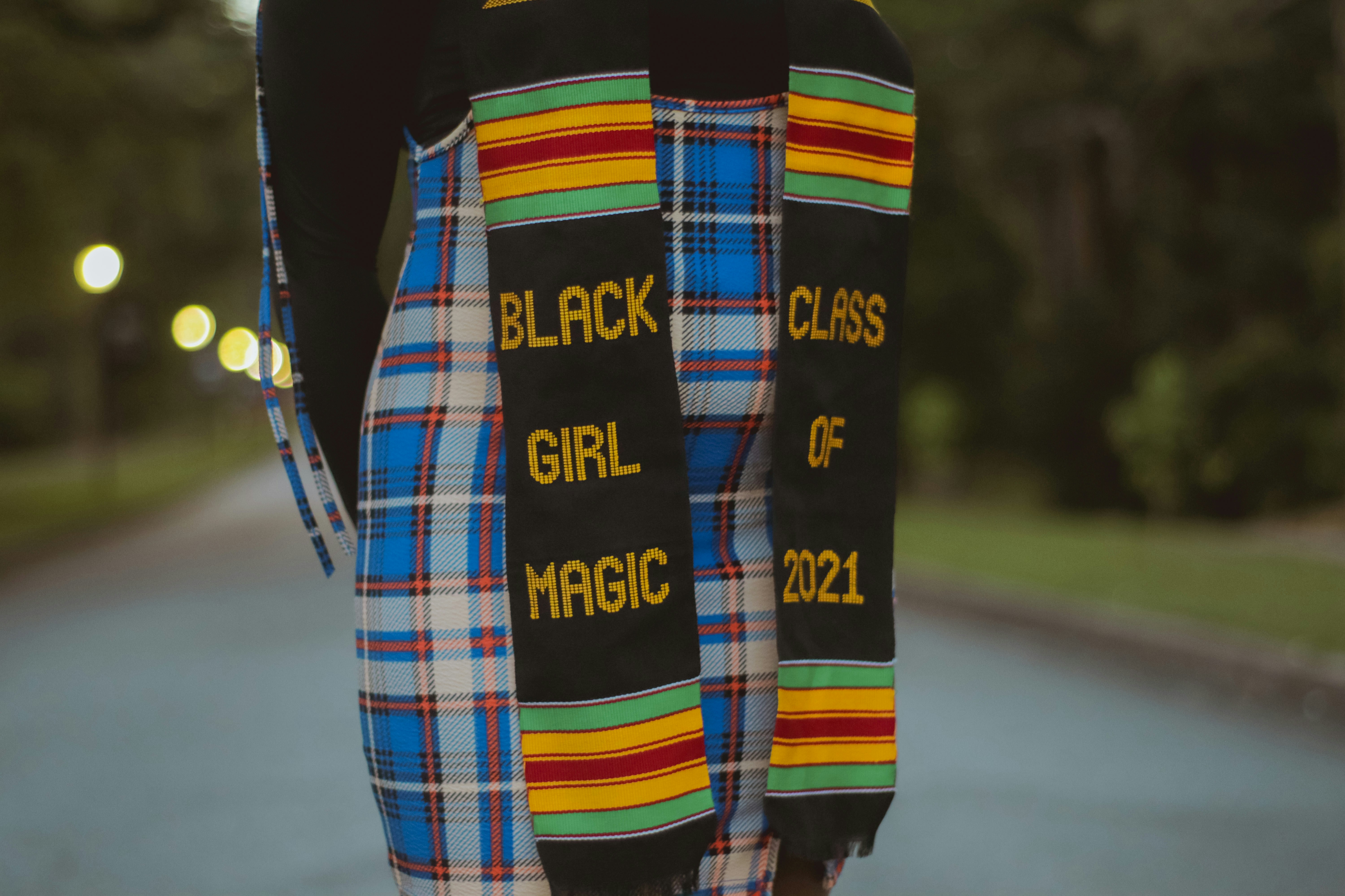 person in black long sleeve shirt with blue white and red plaid scarf