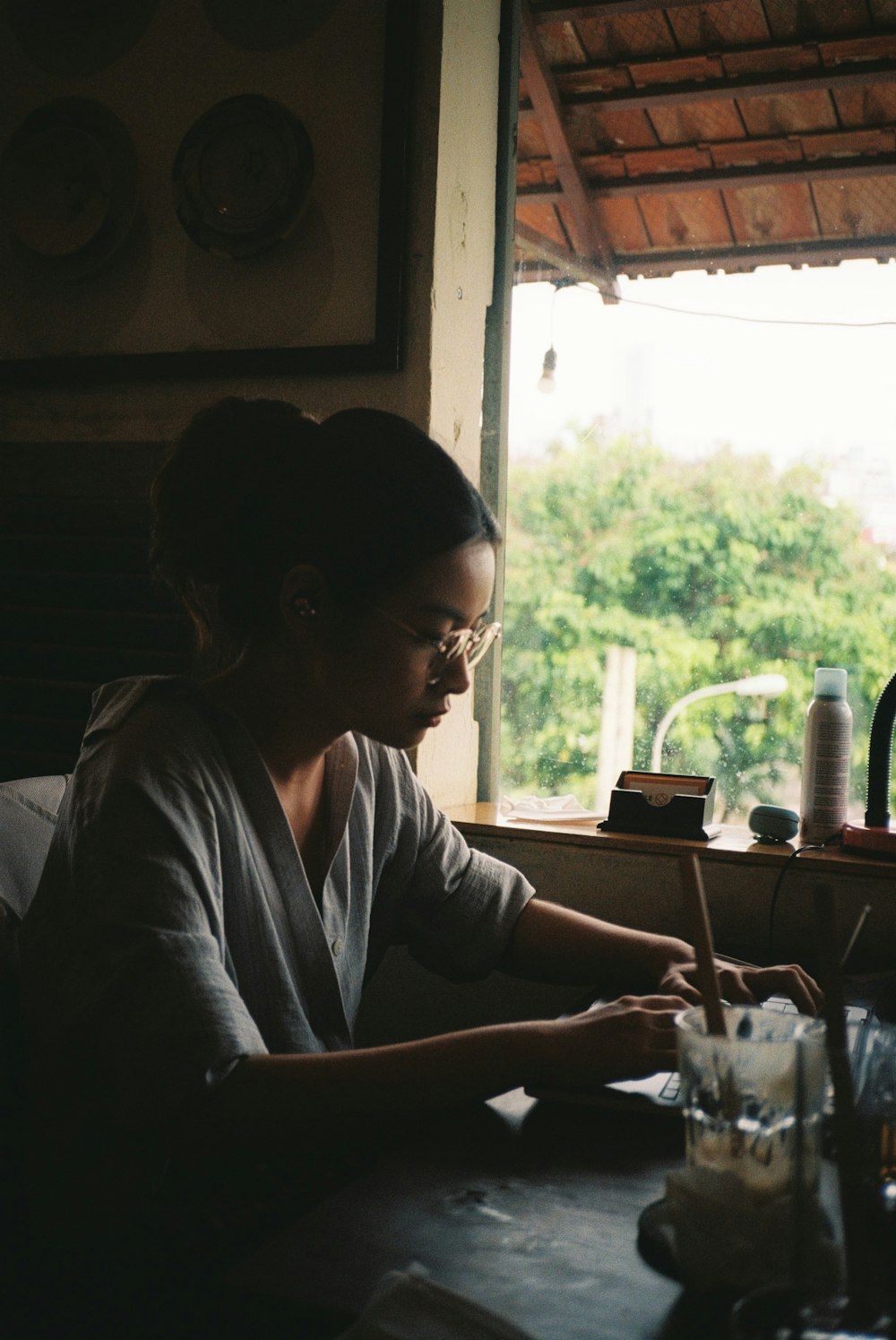 woman in gray long sleeve shirt sitting by the table