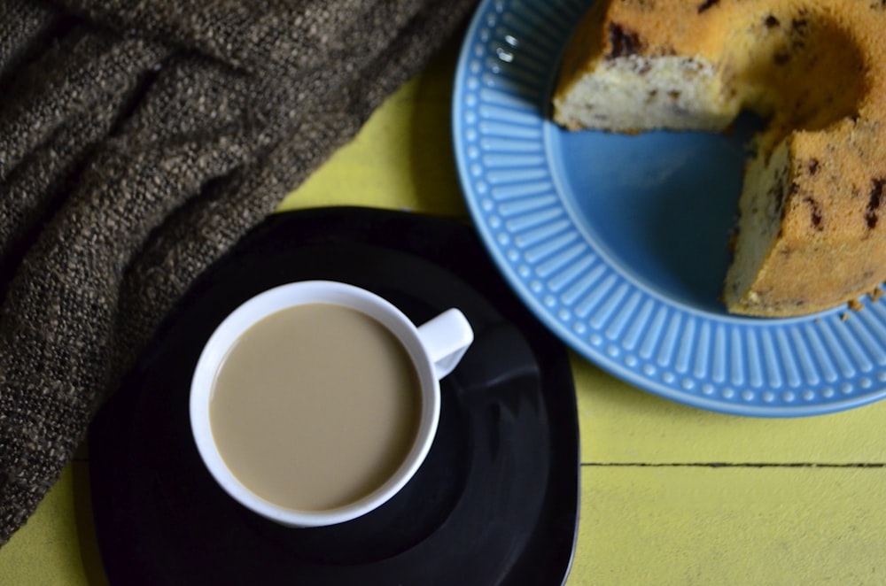 white ceramic mug on blue round plate