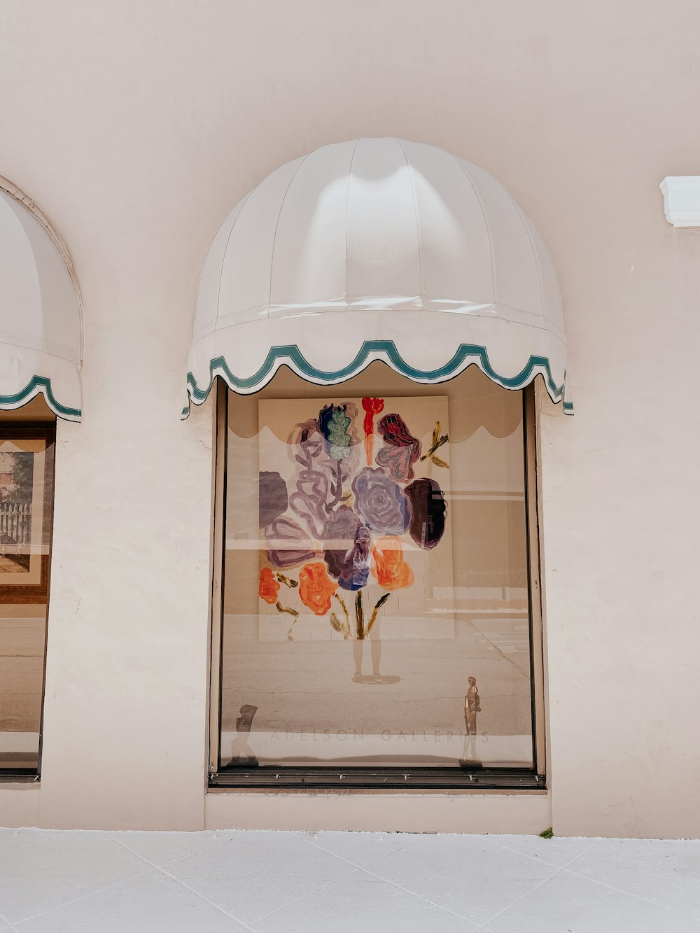 a store front with a flowered window and a white awning