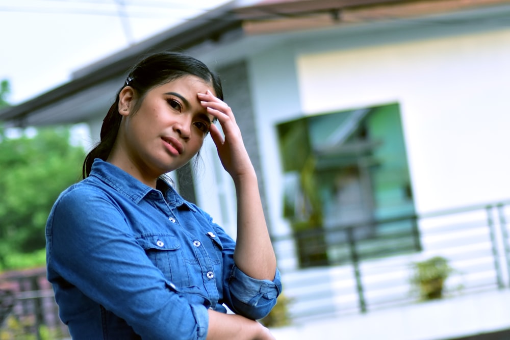 woman in blue denim button up long sleeve shirt