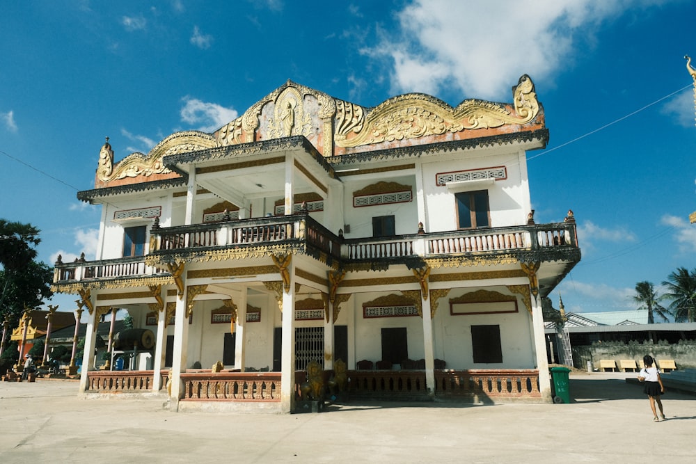 a large white building with a balcony and balconies