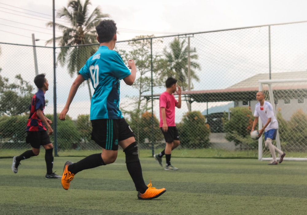 2 boys playing soccer during daytime