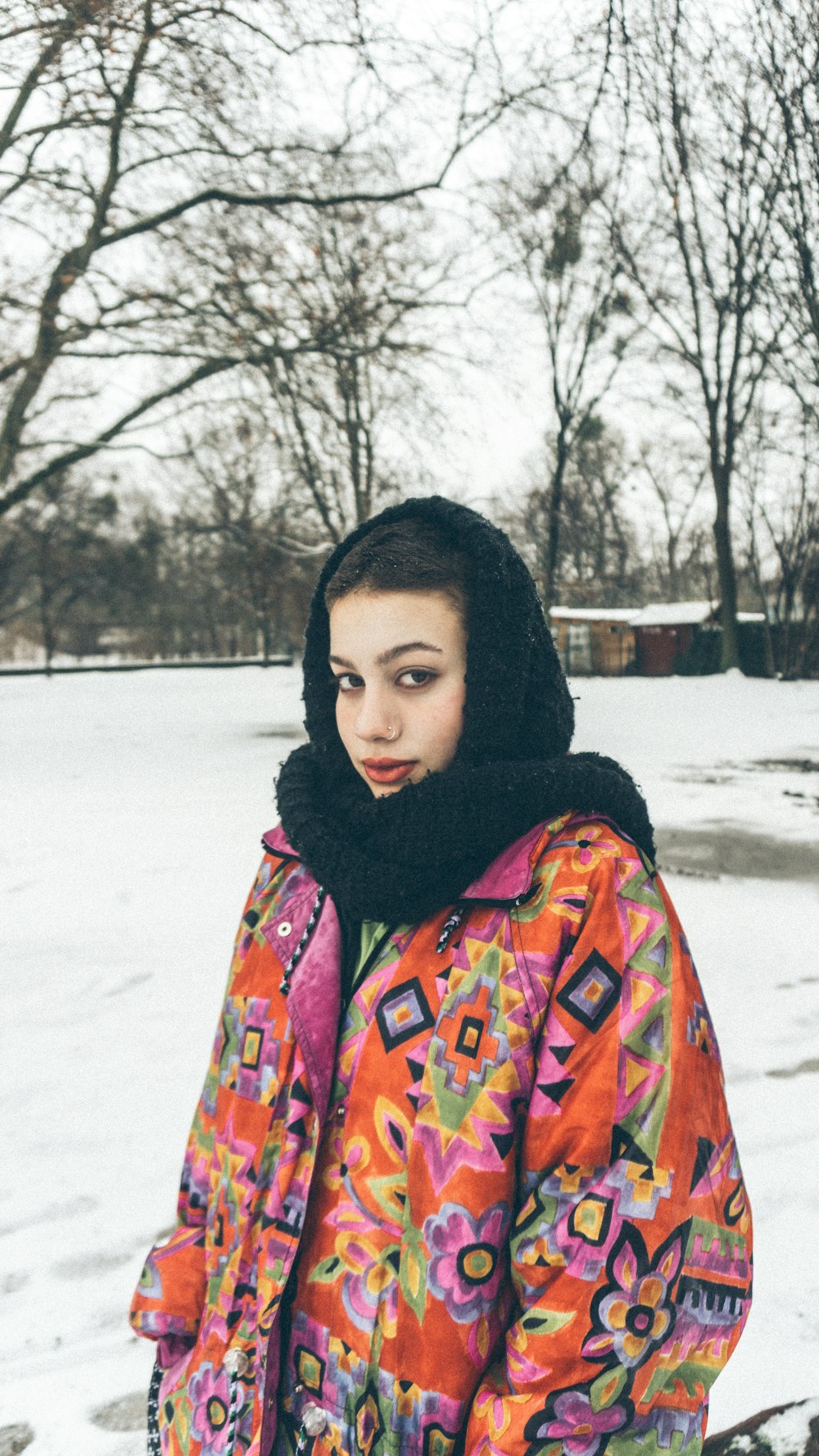 woman in black hijab and red blue and yellow scarf