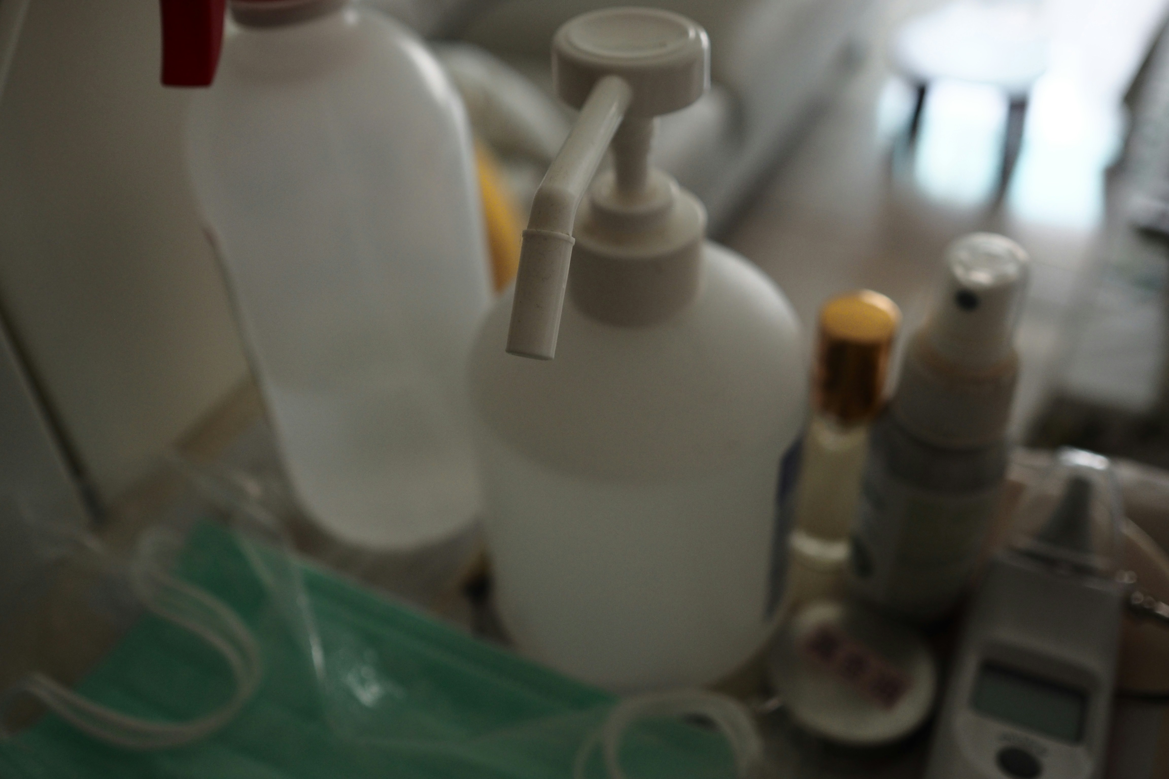 Pharmacy dispensing laboratory with medicine bottles and equipment, bright clinical white environment