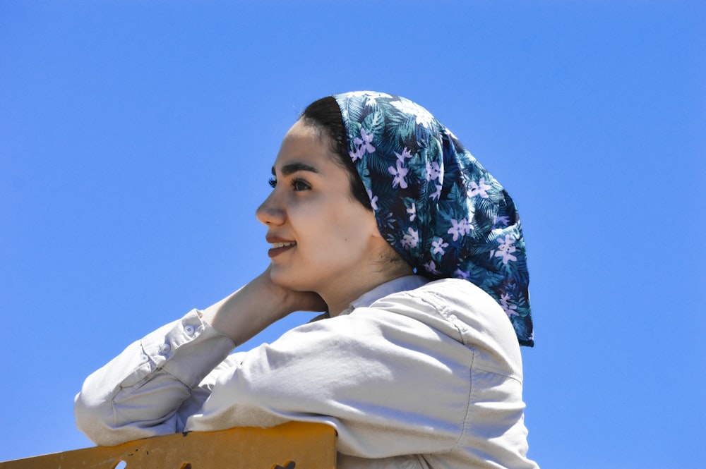 woman in white long sleeve shirt and blue and white floral hijab