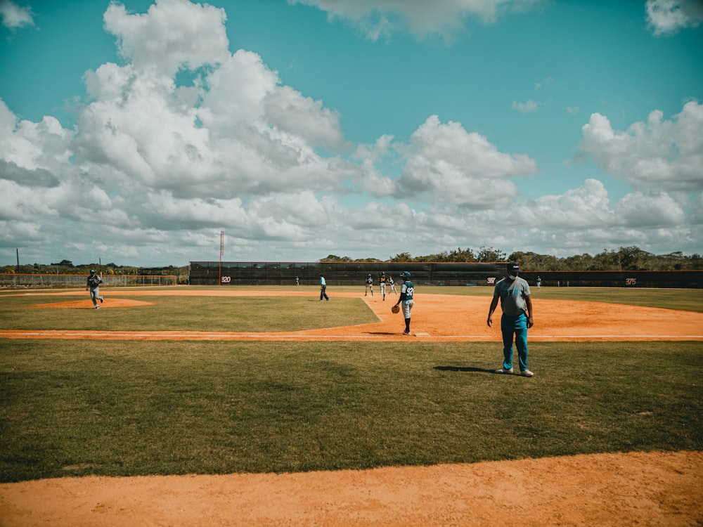 people playing basketball on field during daytime