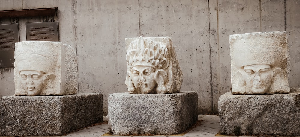 white concrete statue on gray concrete floor