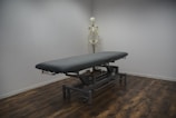 black bed frame on brown wooden parquet floor