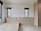 A modern bedroom featuring sleek, minimalist blinds that complement the serene decor.