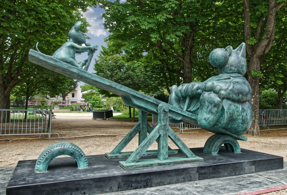 gray concrete statue near green trees during daytime