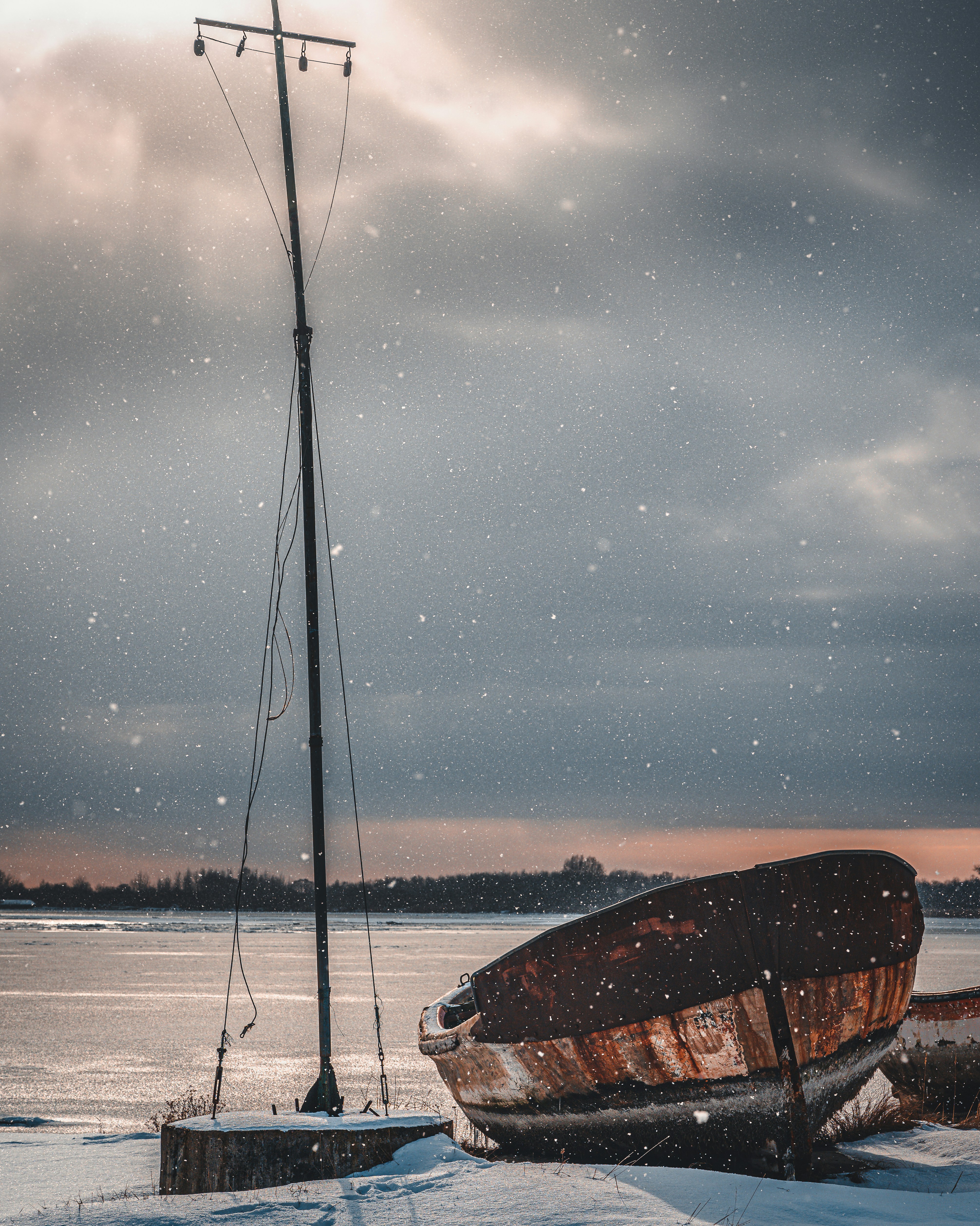 brown boat on sea under gray sky