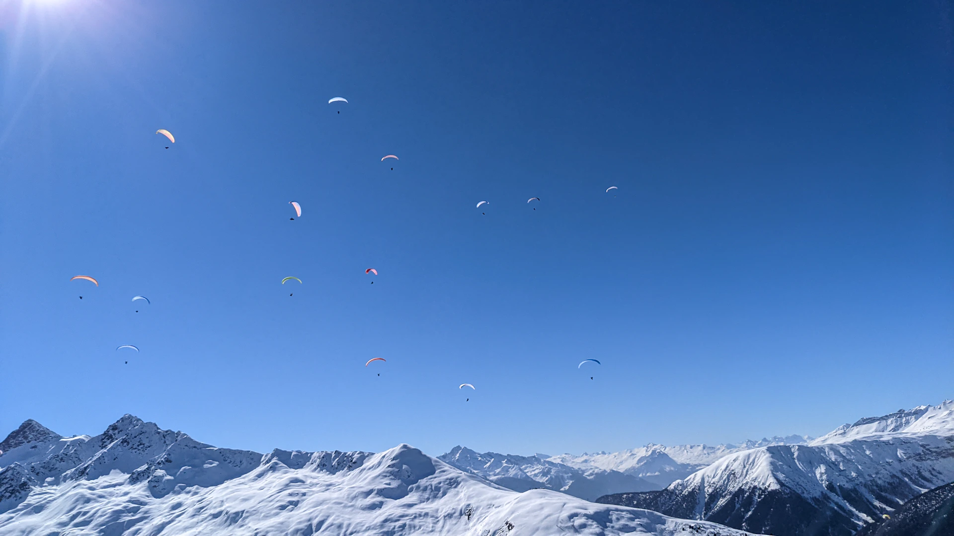 A thrilling moment captured during the paragliding accuracy competition, with colorful parachutes soaring above the scenic Champawat landscape.