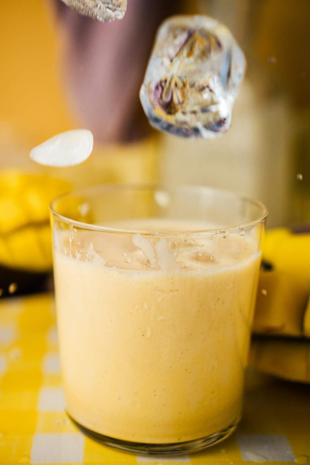 clear drinking glass with yellow liquid