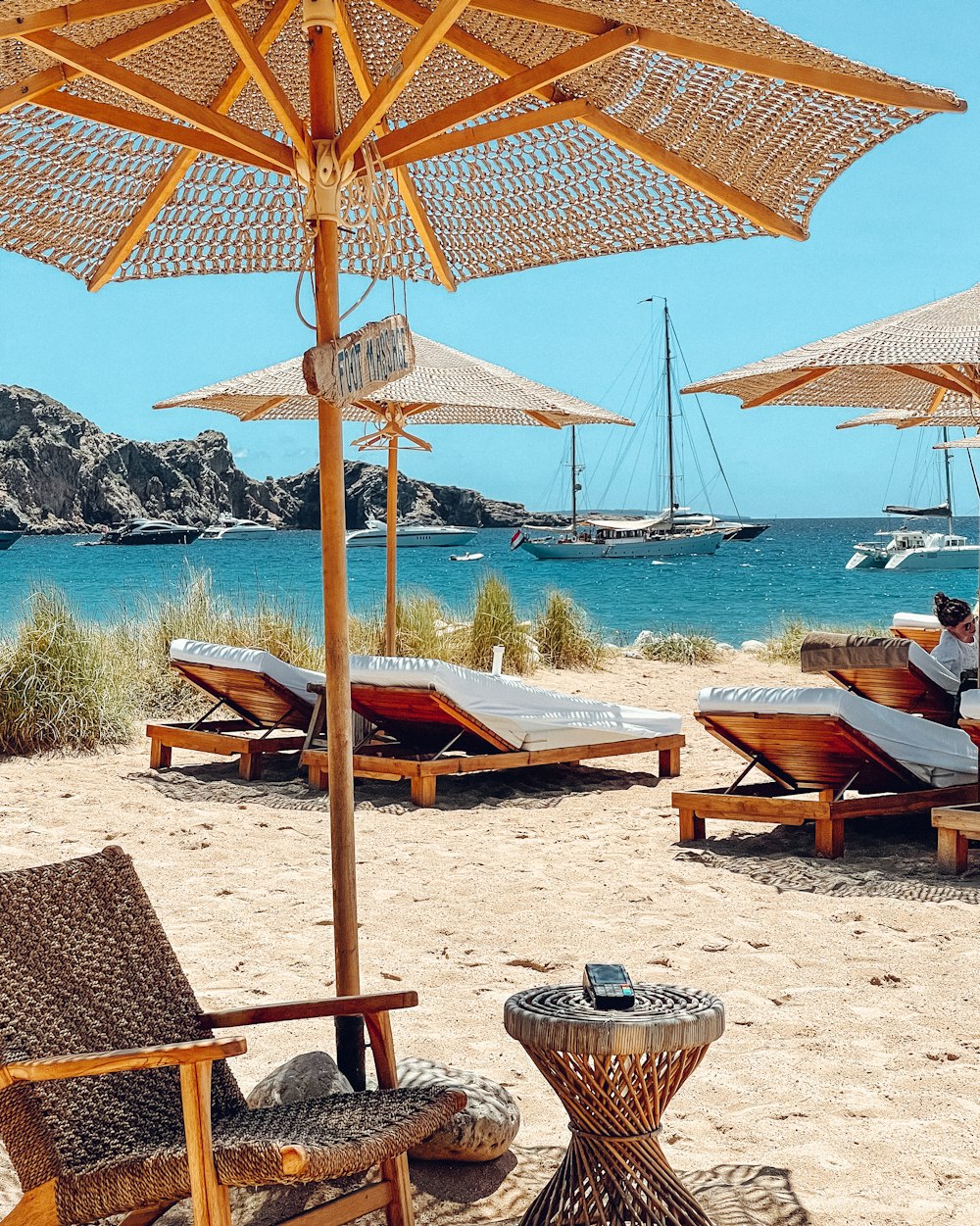 brown wooden beach lounge chairs on beach during daytime