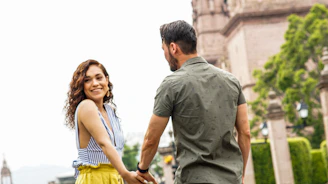 man in gray crew neck t-shirt and woman in yellow and white stripe tank top